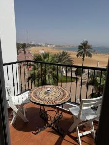 a table and chairs on a balcony with a view of the beach at marina1 in Agadir