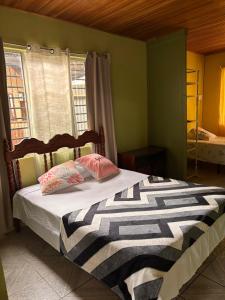 a bedroom with a bed with two pillows on it at Alma Delfina in San Isidro de El General