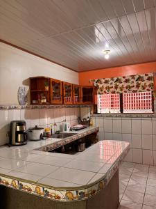 a large kitchen with a large counter in it at Alma Delfina in San Isidro de El General