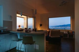 a kitchen and living room with a view of the ocean at Maison Stalettì - Sea View Suite in Copanello