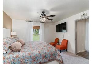 a bedroom with a bed and a ceiling fan at Stylish Home Away From Home in Brooksville