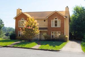 a brick house with a tree in the front yard at Columbus Cornerstone in Columbus