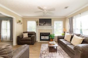 a living room with a couch and a fireplace at Columbus Cornerstone in Columbus +32 photos