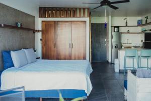 a bedroom with a large bed and a kitchen at Nuevo Vallarta Beachfront Studio - Aria Ocean in Nuevo Vallarta  +39 photos