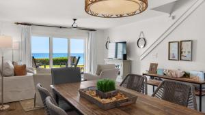 a living room with a table and chairs at Seashadows Townhomes 4 in Seacrest