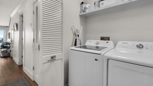 a white laundry room with a washer and dryer at Seashadows Townhomes 4 in Seacrest +34 photos