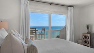 a bedroom with a bed and a view of the ocean at Seashadows Townhomes 4 in Seacrest