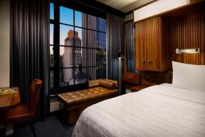 a hotel room with a bed and a window at Le Meridien New York, Central Park in New York
