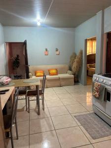 a living room with a table and a couch at Relaxing 2 bedroom with AC, WiFi, Central Location in Golconda