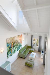 a living room with a couch and a table at Timoon apartment in Orient Bay