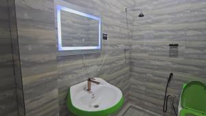 a bathroom with a sink and a window at Arhiba Guest House አርሂባ እንግዳ ማረፊያ 