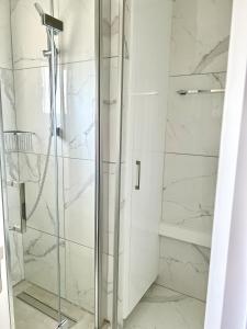 a shower with a glass door in a bathroom at Fully Equipped One Bedroom APT in Limassol