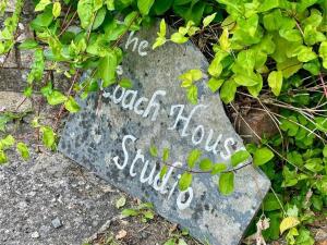 a rock with writing on it on the ground at Coach House Studio, quiet, rural, pet friendly, Probus in Probus