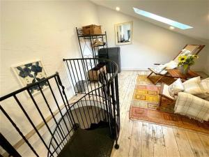 a living room with a staircase and a couch at Coach House Studio, quiet, rural, pet friendly, Probus in Probus