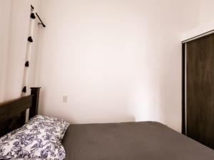 ハコにあるLapa Living Paradise B3 Top floor 2 bedsの白い壁のベッドルーム1室(ベッド1台付)