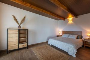 a bedroom with a bed and a wooden ceiling at Penthouse with a View in El Palmital
