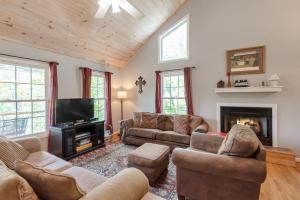 a living room with couches and a tv and a fireplace at 3 Bed Cabin Overlooking the New River-- HOT TUB, Fire Pit, Dogs OK in Obids