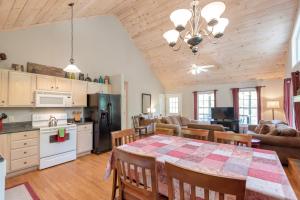 a kitchen and living room with a table and chairs at 3 Bed Cabin Overlooking the New River-- HOT TUB, Fire Pit, Dogs OK in Obids