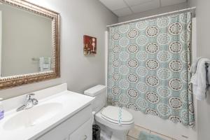 a bathroom with a toilet and a sink and a mirror at 3 Bed Cabin Overlooking the New River-- HOT TUB, Fire Pit, Dogs OK in Obids +26 photos