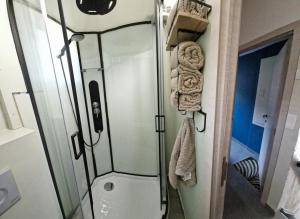 a bathroom with a shower with a glass door at Casa Gaumaise - climatisation réversible et nature in Virton +19 photos