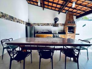 a dining room with a large wooden table and chairs at Ampla casa no centro de Prado in Prado