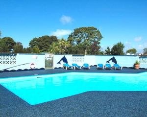 a swimming pool with chairs in front of a building at The Lodge in Newport
