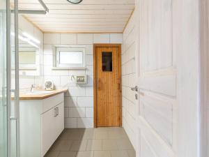 a bathroom with white walls and a wooden door at Ferienpark Mirow, Granzow in Granzow +26 photos