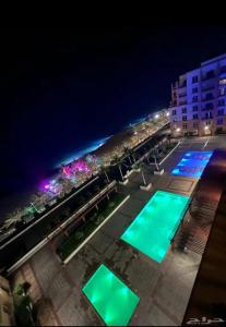 an aerial view of a pool at night at ريفان بيتش ثلاث غرف عوائل واعمال in King Abdullah Economic City