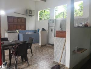 a kitchen with a table with chairs and a refrigerator at Cabaña velez in Capurganá