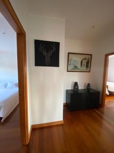 a bedroom with a bed and a picture on the wall at Vivenda Juliano Freitas in Atães +34 photos