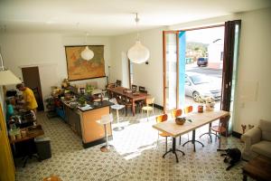 a living room with a man in a kitchen and a table at Casa Fidal in Bordeira
