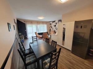 a kitchen and living room with a table and chairs at ZR9 in Zamárdi
