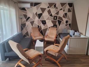 a living room with chairs and a couch at ZR9 in Zamárdi