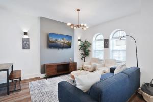 a living room with a blue couch and a table at Contemporary Vintage Home Near Downtown in Bexley