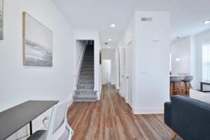 a living room with a staircase and white walls at Contemporary Vintage Home Near Downtown in Bexley