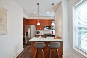 a kitchen with two bar stools and a counter top at Contemporary Vintage Home Near Downtown in Bexley +25 photos