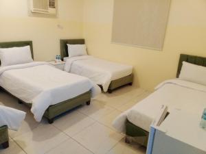 Ένα ή περισσότερα κρεβάτια σε δωμάτιο στο دار الرضا Dar Al Reda