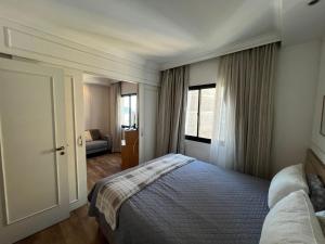 a bedroom with a bed and a window at Hotel Inter Jardins UH1607 in São Paulo