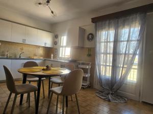 a kitchen with a table and chairs in a kitchen at Chrysalis Apartment in Nea Potidaea +19 photos