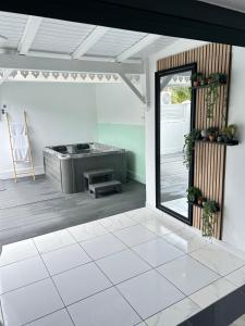 a living room with a stove and a patio at Obuncoeur avec spa in Le Gosier