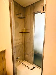 a shower with a glass door in a bathroom at Menlyn Maine Residences in Pretoria +40 photos