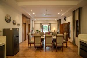 a dining room with a table and chairs at The Medona - A Peaceful Farmstay in Thūr