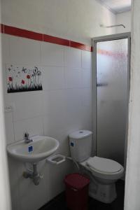 a bathroom with a toilet and a sink at Posada Campestre brisas del camino in Puerto Triunfo +10 photos