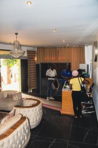 a group of people standing at a counter in a room at Uranium Continental Hotel - UCH in Kaduna +23 photos