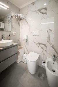 a white bathroom with a toilet and a sink at B&B CaMa in Gragnano +16 photos