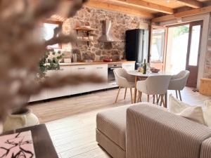 a kitchen and living room with a table and chairs at Casa Rustivéra - Island Hvar in Vrbanj