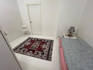 a room with a rug on the floor and a door at 5 beds apartment in Västerås +2 photos
