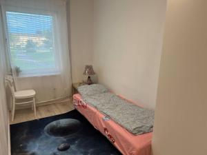 a small bedroom with a bed and a window at 5 beds apartment in Västerås