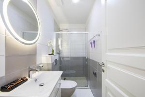 a bathroom with a sink and a toilet and a mirror at Boutique Hotel Melissa in Poreč