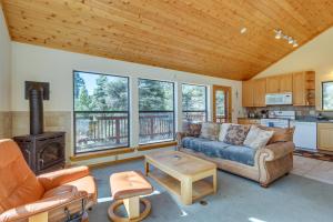 a living room with a couch and a stove at Mtn-View Deck: Cabin Getaway in Angel Fire in Angel Fire